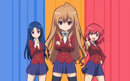 Three anime characters from Toradora!—Taiga Aisaka, Ami Kawashima, and Minori Kushieda—pose confidently against a vibrant blue and red background, showcasing their distinct styles in skirts.
