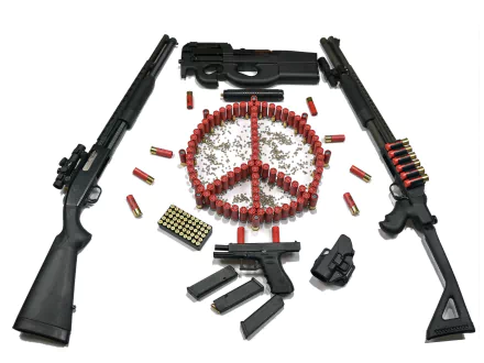A striking HD desktop wallpaper featuring a Benelli M4 and M3 shotgun, Ruger P90, Glock, and scattered bullets arranged in a peace symbol. A bold juxtaposition of firearms and message.