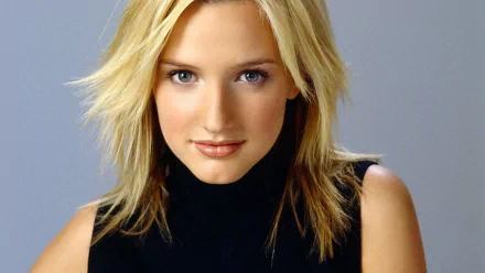Music-themed HD PC desktop wallpaper: polished close-up of a blonde woman in a black turtleneck against a soft gray backdrop.