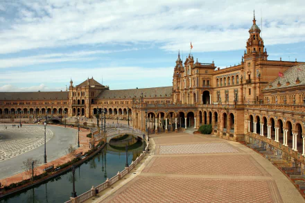 Plaza de España in Seville, Spain, showcases stunning architecture with its grand buildings and serene waterways, providing a captivating view of this iconic man-made landmark.
