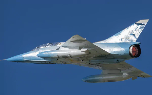 Dassault Mirage III jet fighter warplane soars against a clear blue sky in this HD military aircraft desktop wallpaper.
