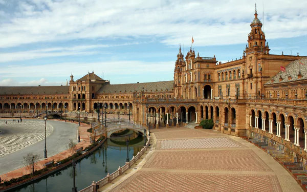 Plaza de España in Seville, Spain, showcases stunning architecture with its grand buildings and serene waterways, providing a captivating view of this iconic man-made landmark.