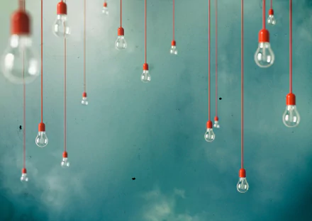 A collection of hanging light bulbs against a soft blue background, creating a modern and artistic desktop wallpaper. The design features a man-made aesthetic with simple elegance.