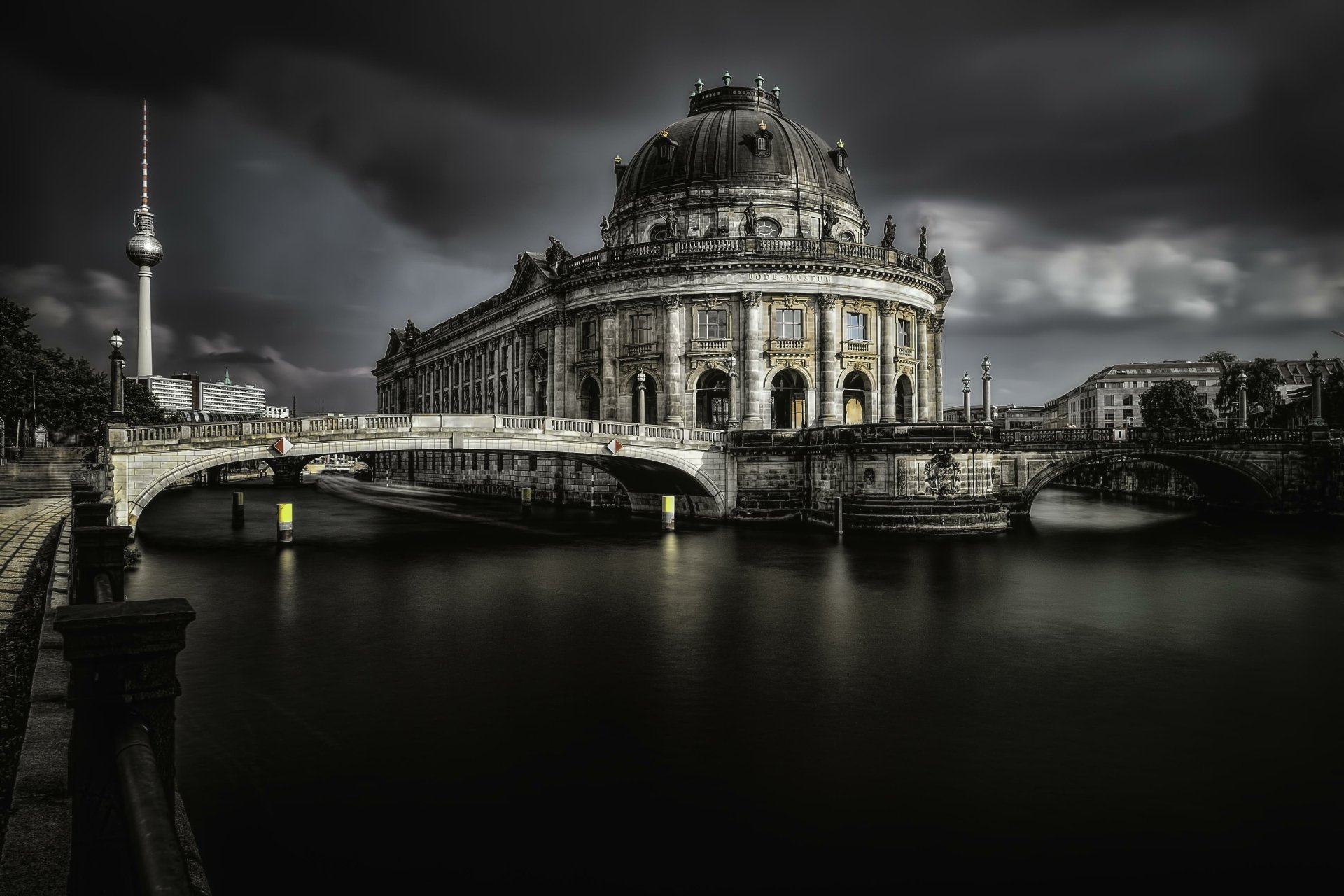 4K Ultra HD view of Berlin’s Bode Museum with its dome and historic architecture along the river under a dramatic cloudy sky, showcasing the city’s man-made beauty.