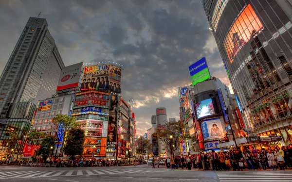 A vibrant Tokyo cityscape at dusk, showcasing bustling crowds and striking man-made architecture, illuminated by colorful advertisements in HDR quality.
