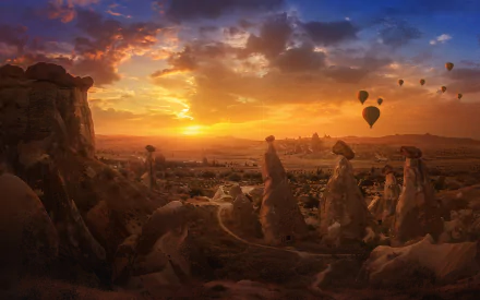 Sunset over Cappadocia's canyon in Turkey, with hot air balloons floating above the unique rock formations in this vibrant HD landscape.