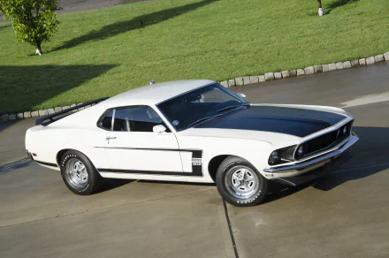 White 1969 Ford Mustang Boss 302 muscle car with black hood stripes parked on a driveway — HD PC desktop wallpaper background.