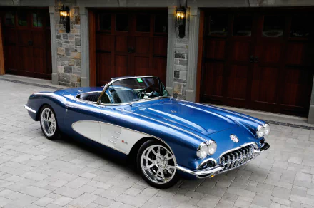 A blue 1959 Chevrolet Corvette hot rod muscle car parked in front of stone garage doors, captured in high definition as a PC desktop wallpaper.