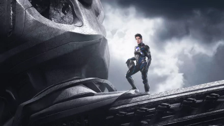 Zack Taylor as the Black Ranger stands confidently beside a towering Zord in this striking 4K Ultra HD wallpaper from the 2017 Power Rangers movie.