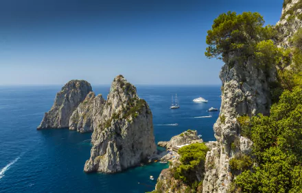 Stunning 4K Ultra HD image of Capri, Italy, featuring boats sailing near rocky cliffs at the sea horizon under a clear blue sky.