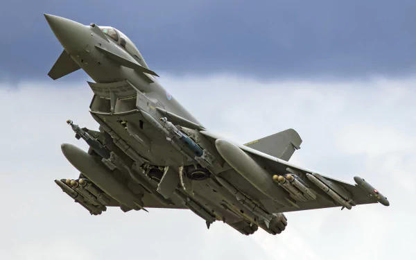 HD desktop wallpaper featuring a Eurofighter Typhoon jet fighter warplane in flight against a cloudy sky background.