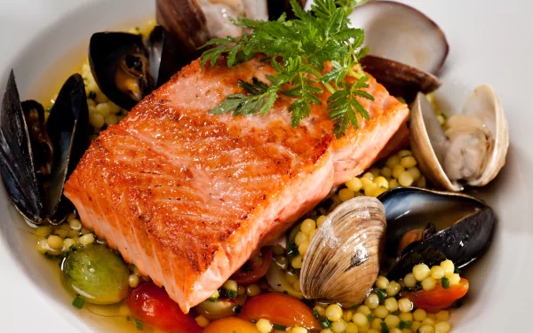 A vibrant seafood meal featuring a seared salmon fillet atop couscous with clams, mussels, and garnished with fresh herbs, captured in 4K Ultra HD detail.