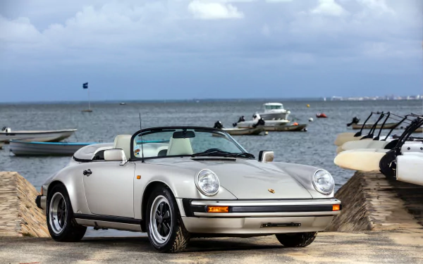 White Porsche 911 Carrera convertible parked near a marina with boats, captured in 4K Ultra HD as a PC desktop wallpaper and background.