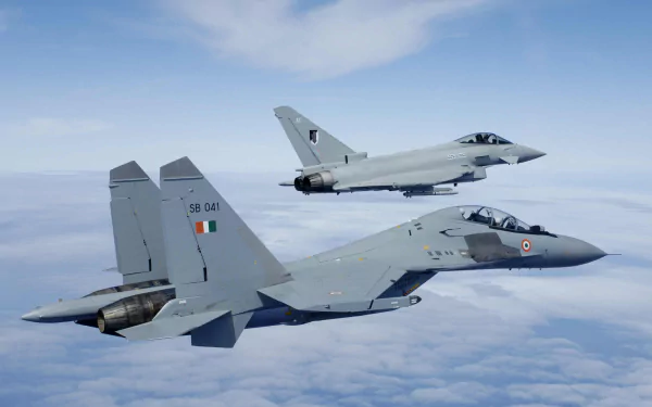Two military jet fighters, a Sukhoi Su-30MKI and a Sukhoi Su-30, soaring above the clouds in a clear blue sky, captured in an HD desktop wallpaper.