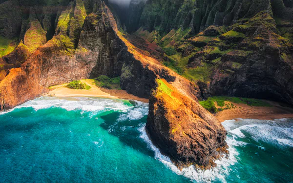 A stunning aerial view of Kauai's rugged coastline, featuring vibrant cliffs and turquoise ocean waves. Nature's beauty is on full display in this captivating Hawaiian setting.