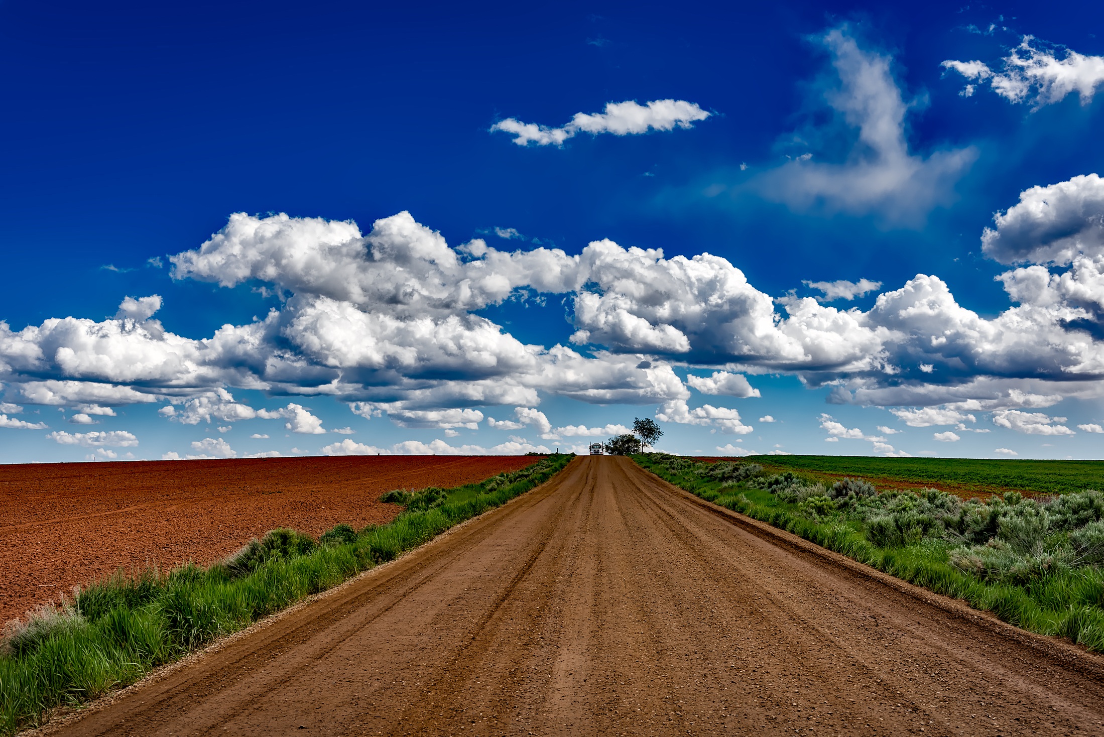 semi-truck-traveling-down-a-dirt-road-in-colorado-by-12019