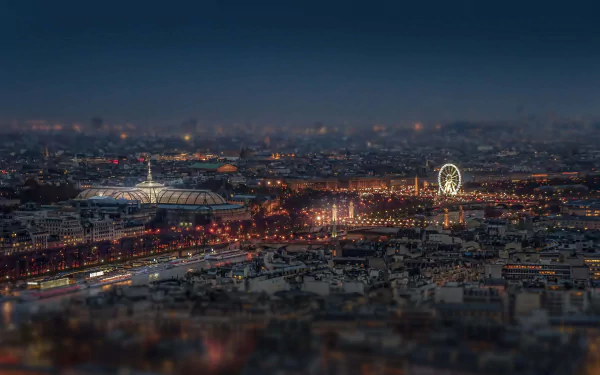 Tilt-shift nighttime cityscape of Paris, France, showcasing illuminated streets and landmarks in stunning 4K Ultra HD detail.