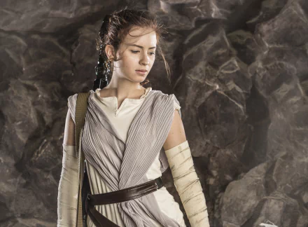 HD PC desktop wallpaper featuring a woman cosplaying as Rey from Star Wars, set against a rocky background.