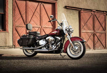 Harley-Davidson Heritage Softail Classic motorcycle parked in front of rustic garage doors — HD PC desktop wallpaper/background showcasing the Harley-Davidson Heritage Softail.