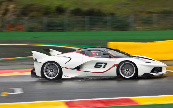 White Ferrari FXX K race vehicle (#61) streaking on a wet track with motion blur — 4K Ultra HD PC desktop wallpaper and background.