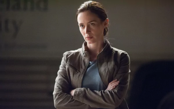 Cinematic 4K UHD PC wallpaper: stern woman in a jacket, arms crossed in a dim, tense movie crime-thriller scene.