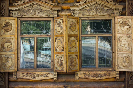 Ornate wooden window shutters with intricate carvings on a traditional man-made house in Orenburg, captured in sharp 4K Ultra HD detail.