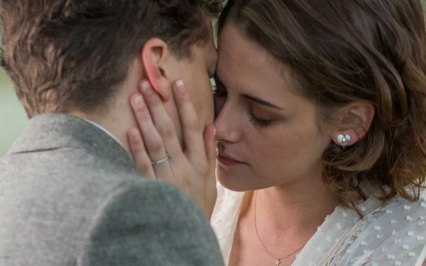 Close-up of Kristen Stewart and Jesse Eisenberg sharing an intimate moment from the movie Cafe Society, featured in an HD PC desktop wallpaper.
