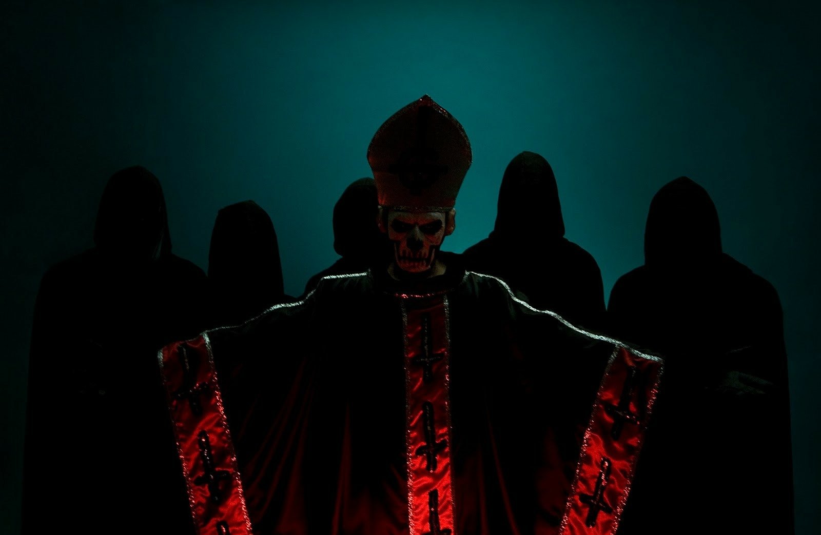 HD desktop wallpaper featuring a dramatic image of the heavy metal band Ghost B.C., with members in dark, hooded robes and one figure in a red and black ceremonial outfit, creating an eerie atmosphere.