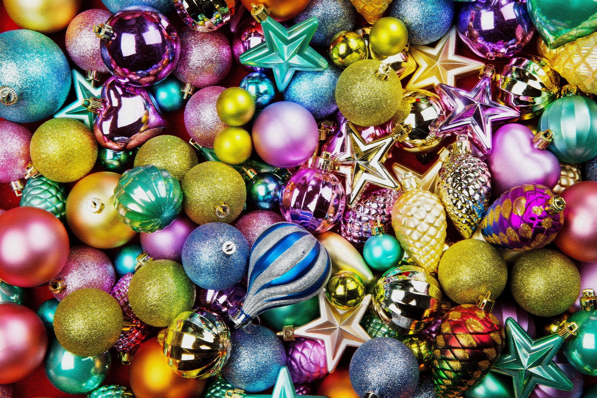 A vibrant collection of colorful Christmas ornaments, including balls and stars, creating a festive holiday scene in 4K Ultra HD quality for desktop wallpaper.