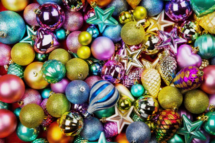 A vibrant collection of colorful Christmas ornaments, including balls and stars, creating a festive holiday scene in 4K Ultra HD quality for desktop wallpaper.