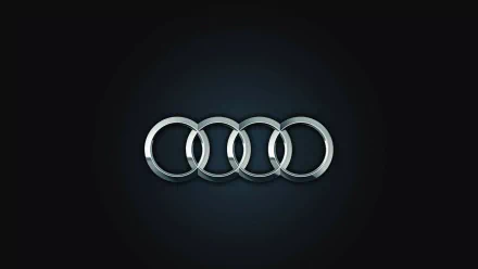 HD desktop wallpaper featuring the illuminated Audi logo with four silver rings on a black background.