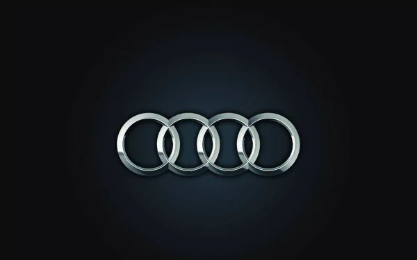 HD desktop wallpaper featuring the illuminated Audi logo with four silver rings on a black background.