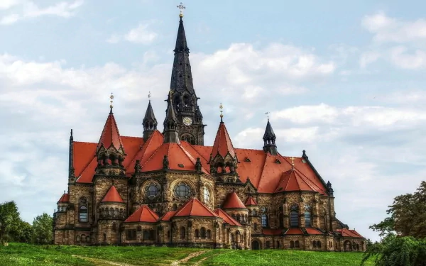 HD desktop wallpaper of the Garnison Church of St. Martin in Dresden, Germany, showcasing its detailed religious architecture under a partly cloudy sky.