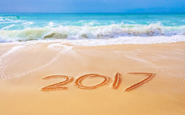 Tropical beach with sea waves and horizon, 2017 written in sand, capturing a New Year holiday vibe in vibrant 8K Ultra HD resolution.