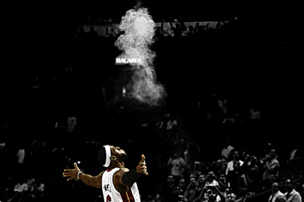 HD wallpaper featuring a monochrome image of a basketball player performing a pre-game ritual with powder.
