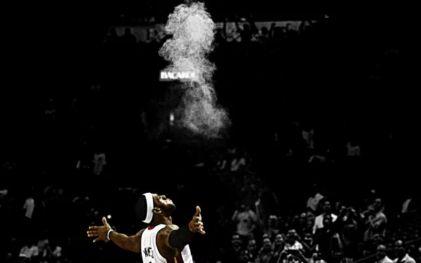 HD wallpaper featuring a monochrome image of a basketball player performing a pre-game ritual with powder.