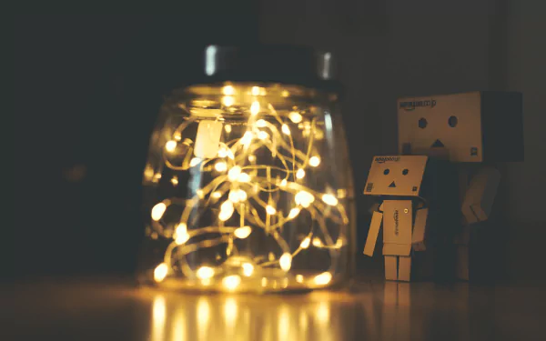 A 4K Ultra HD desktop wallpaper featuring a glowing jar filled with fairy lights beside two Danbo figures in a dimly lit setting.
