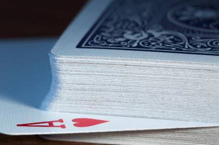 Close-up of a deck of playing cards with the Ace of Hearts peeking out, captured in high definition. A crisp, detailed HD desktop wallpaper and background.