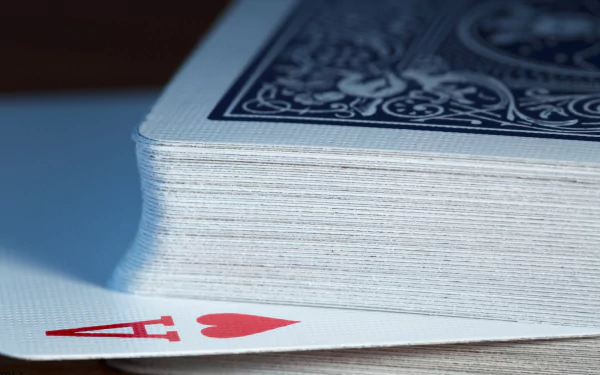 Close-up of a deck of playing cards with the Ace of Hearts peeking out, captured in high definition. A crisp, detailed HD desktop wallpaper and background.