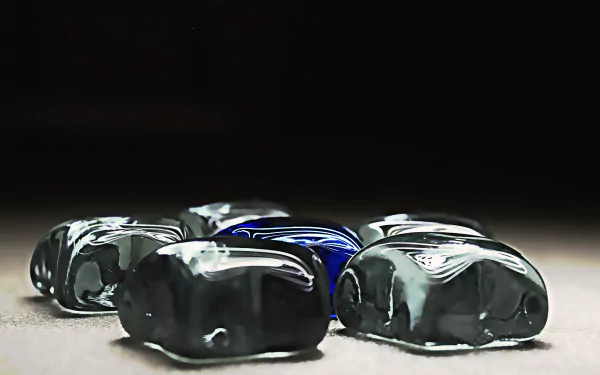 Artistic blue crystal pentagon arrangement on a dark surface, high-detail 5K Ultra HD PC desktop wallpaper background with reflective stones and dramatic lighting.