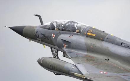 Close-up of a Dassault Mirage 2000 military jet fighter in flight, captured in high definition for a PC desktop wallpaper background.