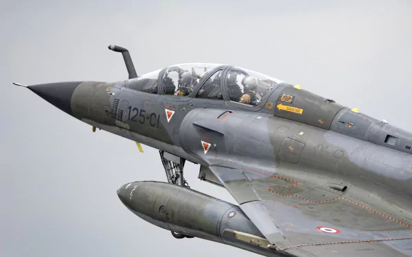 Close-up of a Dassault Mirage 2000 military jet fighter in flight, captured in high definition for a PC desktop wallpaper background.