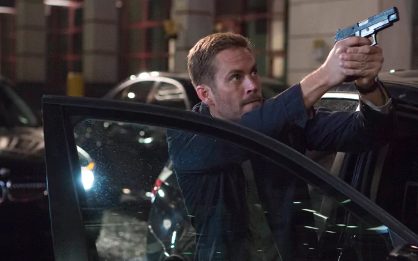 HD wallpaper and background featuring Brian O'Conner (Paul Walker) from Fast & Furious 6 in an action scene, aiming a gun while standing beside a car at night.