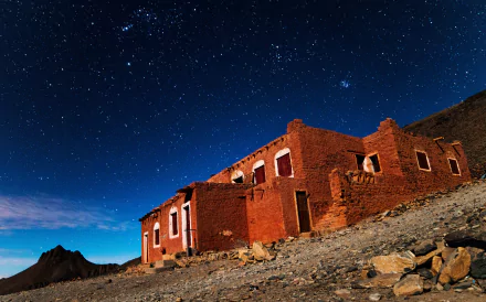 Starry night over a man-made house in the Hoggar Mountains, Tassili N'Ajjer, Algeria, Africa, captured in stunning 4K Ultra HD resolution.