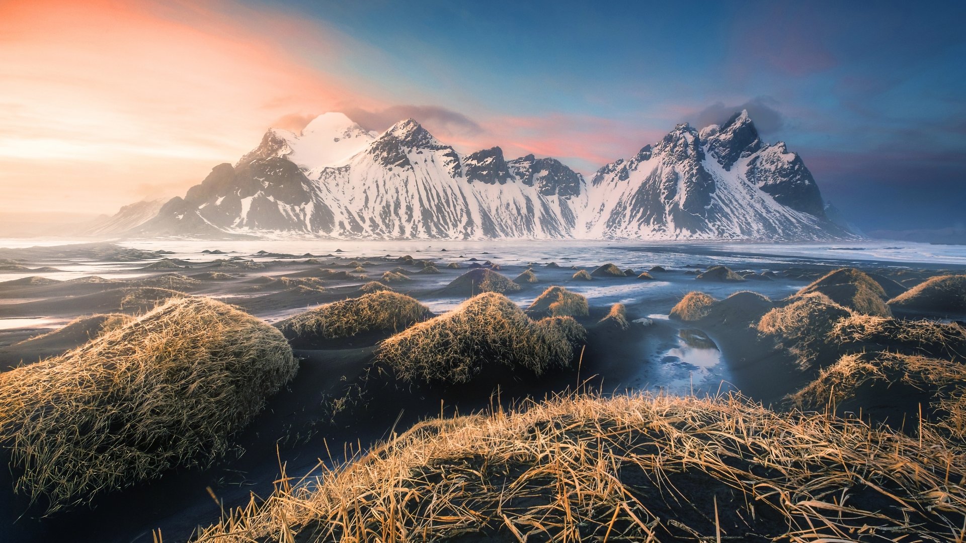 HD desktop wallpaper showcasing Vestrahorn Mountain in Iceland, with snow-capped peaks, sandy foreground, and vibrant sky, highlighting the stunning natural beauty of Vestrahorn.