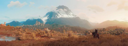 HD desktop wallpaper of The Witcher 3: Wild Hunt featuring a vast landscape with a towering snow-capped mountain in the background and a lone figure on horseback in the foreground.