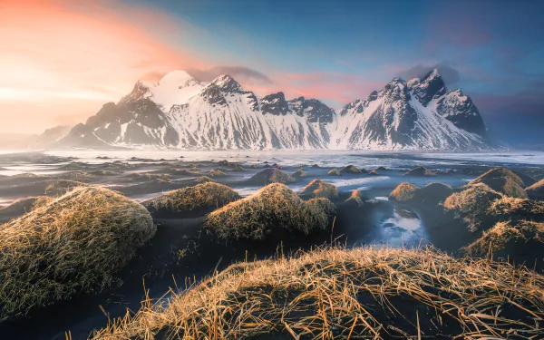 HD desktop wallpaper showcasing Vestrahorn Mountain in Iceland, with snow-capped peaks, sandy foreground, and vibrant sky, highlighting the stunning natural beauty of Vestrahorn.