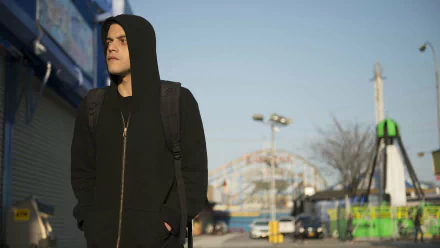 HD PC desktop wallpaper featuring a scene from the TV show Mr. Robot with the protagonist wearing a black hoodie in an urban setting.