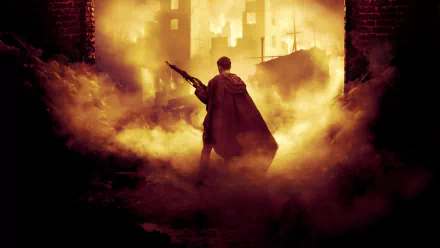 HD PC desktop wallpaper from the movie Enemy At The Gates, showing a lone soldier holding a rifle amidst smoke and a fiery, war-torn urban backdrop.
