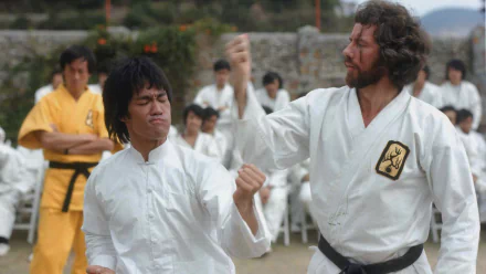 HD PC desktop wallpaper from the movie Enter the Dragon: two martial artists in white gis spar in an outdoor training courtyard while others watch.